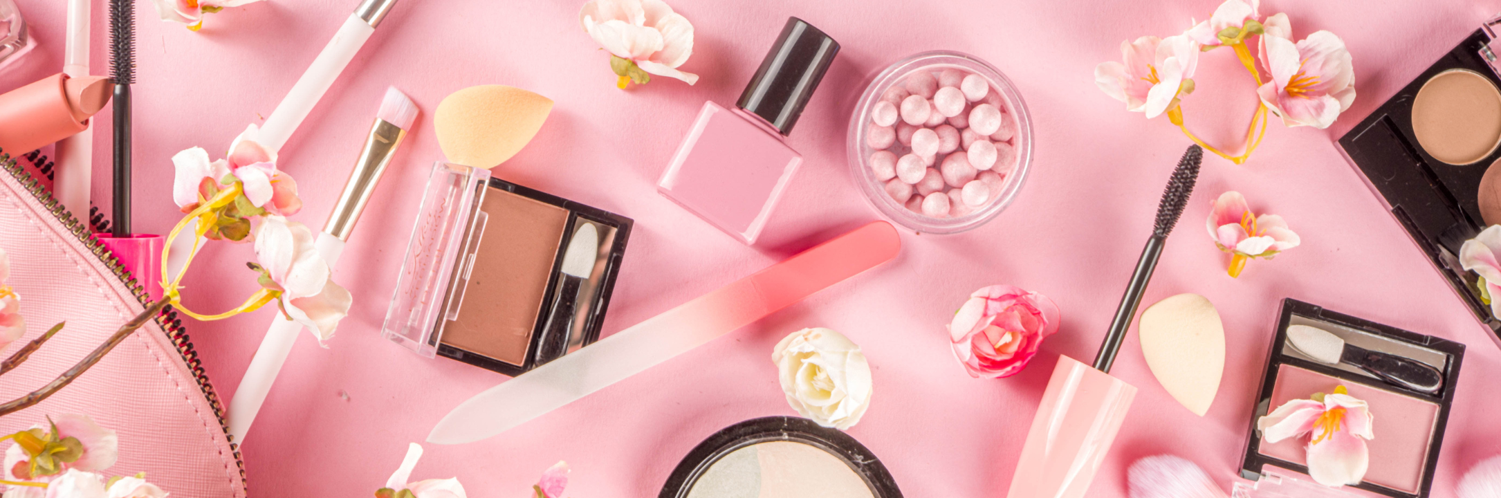 A collection of makeup products, including foundation, lipstick, and eyeshadow, arranged on a vanity, showcasing the tools used for beauty and self-expression