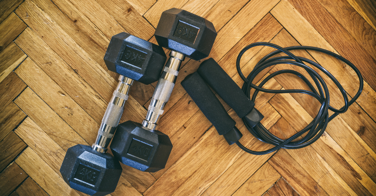 Person performing kettlebell swing next to dumbbells in a gym