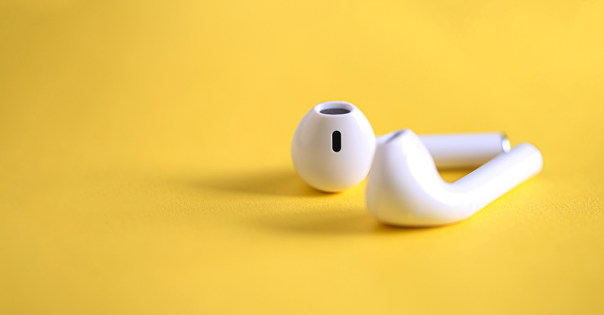 Close-up of AirPods wireless earbuds with a sleek white design, showcasing their minimalist build and seamless connectivity features. Available at CA International.