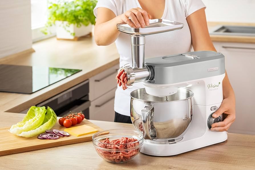 Multi-function energy-efficient food processor in action, chopping ingredients in a sleek kitchen.